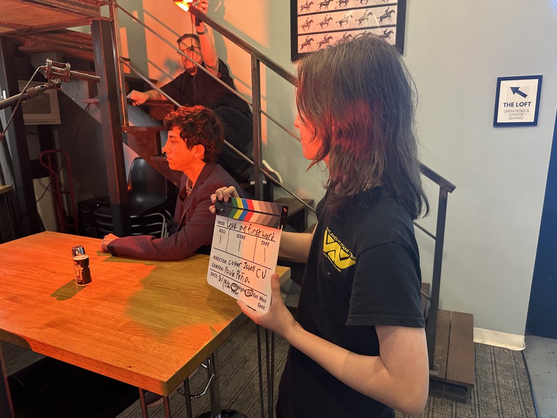 A crew member holding up the slate before a take
